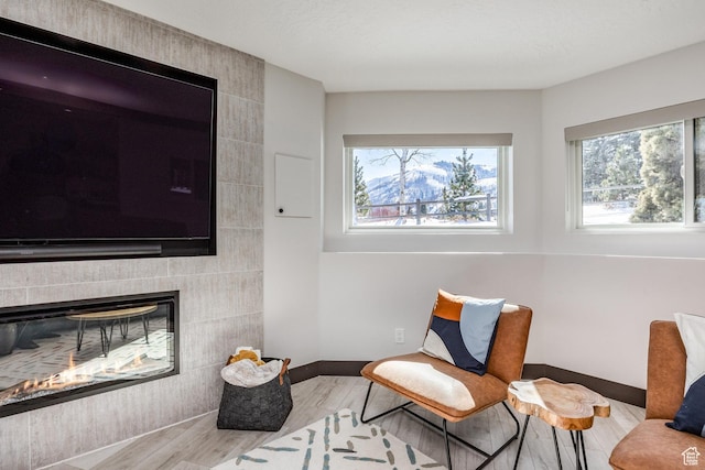 12 Thaynes Canyon Dr, Park City, UT 84060 - sitting room with a textured ceiling, a tiled fireplace, baseboards, and wood finished floors