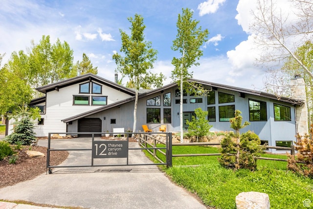 12 Thaynes Canyon Dr, Park City, UT 84060 - mid-century home featuring driveway, a garage, a chimney, and fence
