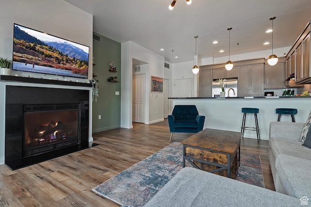 350 S 200 E Unit 404, Salt Lake City, UT 84111 - living room with a fireplace with flush hearth, baseboards, wood finished floors, and recessed lighting