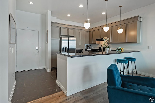 350 S 200 E Unit 404, Salt Lake City, UT 84111 - kitchen with dark countertops, a peninsula, appliances with stainless steel finishes, and recessed lighting
