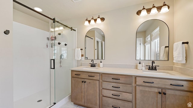 full bath featuring double vanity, a shower stall, and a sink