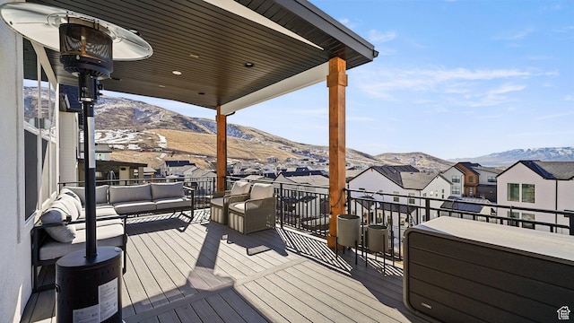 wooden terrace with a mountain view, a residential view, and outdoor lounge area