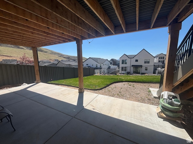 view of patio with a residential view and a fenced backyard
