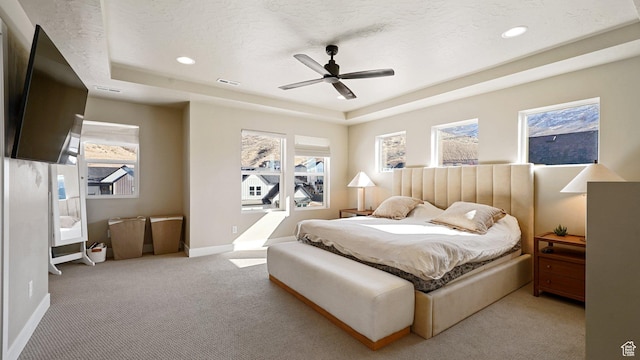 bedroom with baseboards, visible vents, carpet, recessed lighting, and a raised ceiling