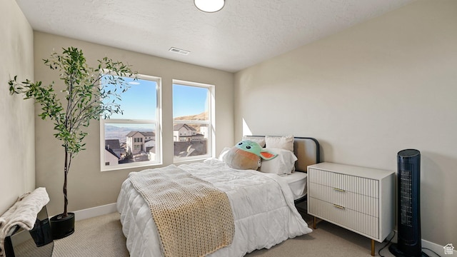 bedroom with radiator, visible vents, baseboards, a textured ceiling, and carpet flooring