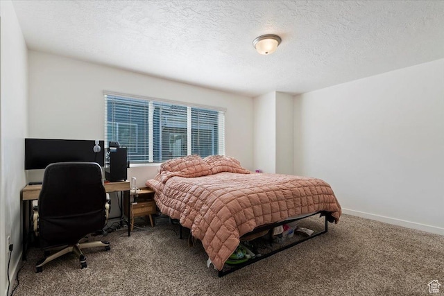 bedroom featuring a textured ceiling, carpet flooring, and baseboards