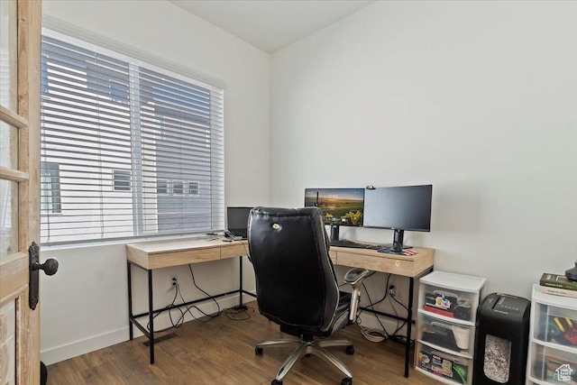home office featuring wood finished floors, visible vents, and baseboards
