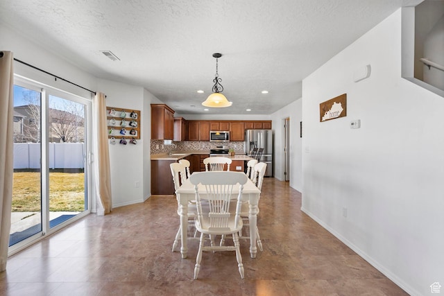 5906 Columbus Cir, Stansbury Park, UT 84074 - dining space featuring baseboards, a textured ceiling, and recessed lighting