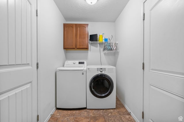 5906 Columbus Cir, Stansbury Park, UT 84074 - laundry room with cabinet space, washing machine and clothes dryer, a textured ceiling, and baseboards