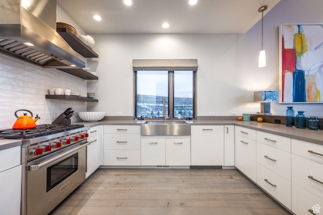 6379 W Golden Bear Loop, Park City, UT 84098 - kitchen featuring white cabinets, light wood-style floors, luxury stove, wall chimney exhaust hood, and a sink