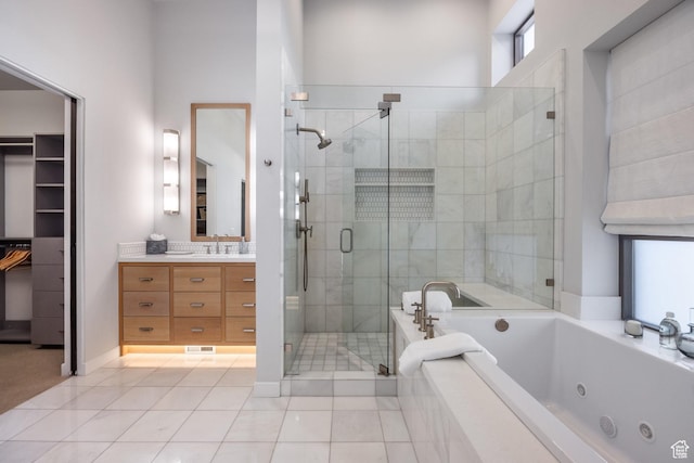 6379 W Golden Bear Loop, Park City, UT 84098 - bathroom with vanity, a spacious closet, a tub with jets, tile patterned flooring, and a stall shower
