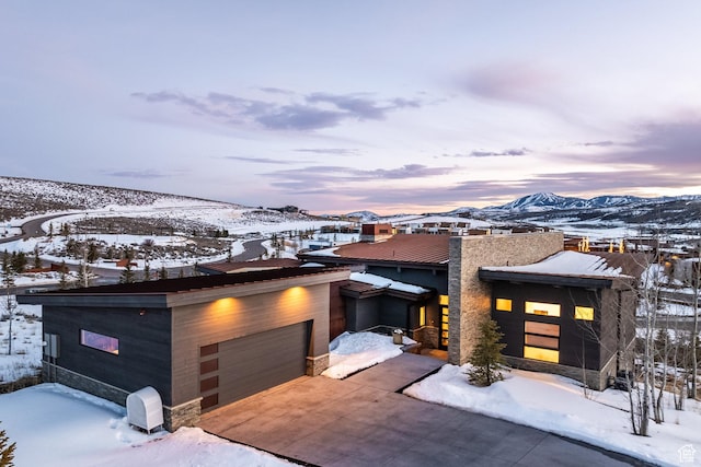 view of front of home with a mountain view and concrete driveway