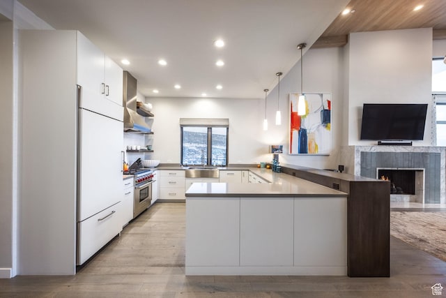 6379 W Golden Bear Loop, Park City, UT 84098 - kitchen featuring white fridge, a peninsula, open shelves, wall chimney exhaust hood, and high end stainless steel range