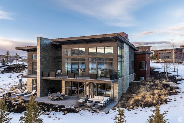 6379 W Golden Bear Loop, Park City, UT 84098 - snow covered back of property with a patio area, a balcony, and stone siding