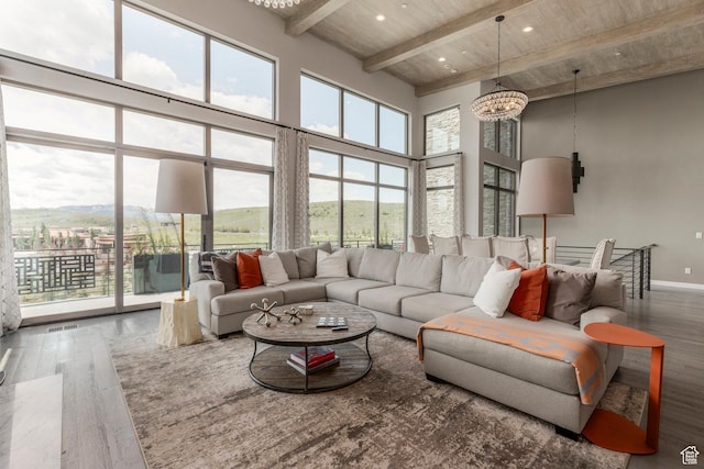 6379 W Golden Bear Loop, Park City, UT 84098 - living area featuring wood-type flooring, a towering ceiling, a wood ceiling with exposed beams, and a chandelier