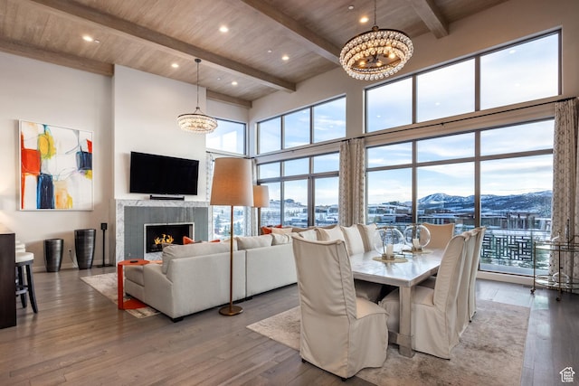 6379 W Golden Bear Loop, Park City, UT 84098 - dining area with an inviting chandelier, a high ceiling, hardwood / wood-style floors, a tile fireplace, and wooden ceiling