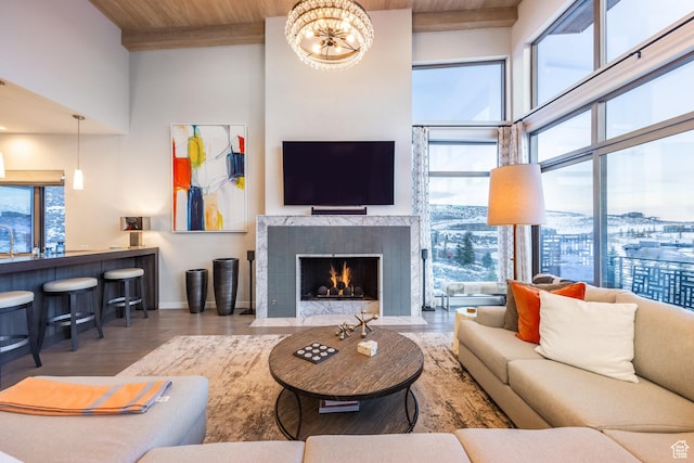 6379 W Golden Bear Loop, Park City, UT 84098 - living room featuring a tiled fireplace, a towering ceiling, baseboards, and wood finished floors