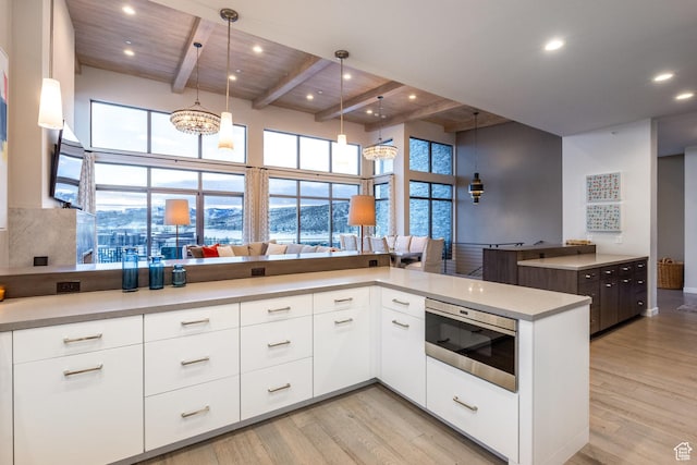 6379 W Golden Bear Loop, Park City, UT 84098 - kitchen with stainless steel microwave, light countertops, light wood-type flooring, and modern cabinets
