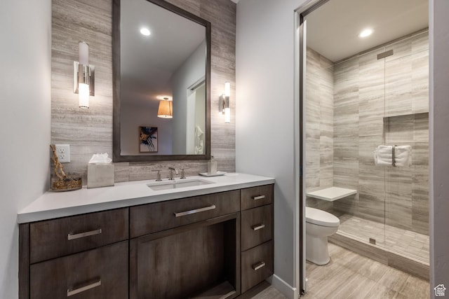 6379 W Golden Bear Loop, Park City, UT 84098 - full bathroom with toilet, a shower stall, vanity, wood finished floors, and decorative backsplash