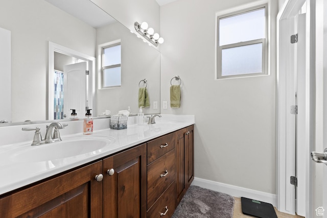 529 E Dry Ln, Washington, UT 84780 - bathroom featuring double vanity and baseboards