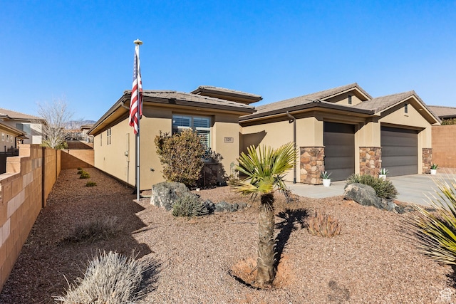 529 E Dry Ln, Washington, UT 84780 - view of front of property with a garage, driveway, stucco siding, and stone siding