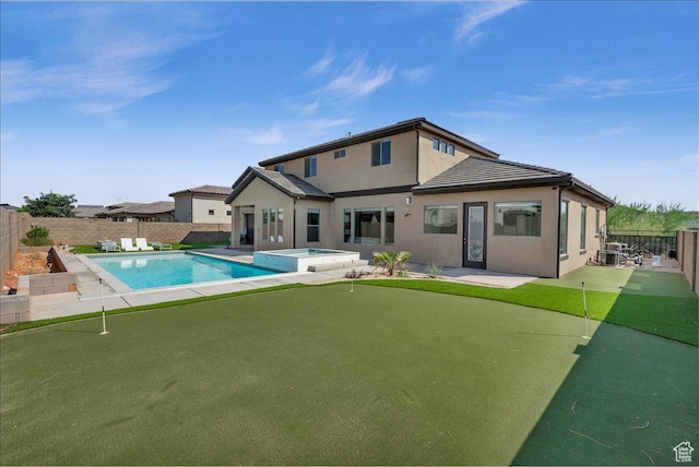 back of house with a patio area, a fenced backyard, a pool with connected hot tub, and stucco siding