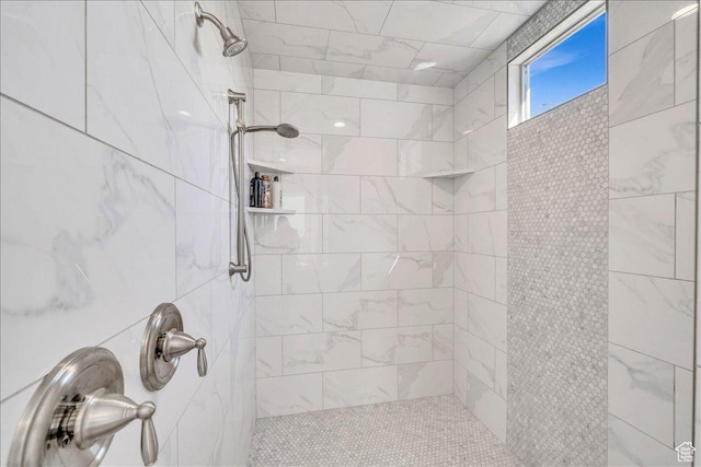 full bath with a tile shower