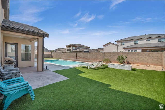 view of yard with a patio, a fenced backyard, and a fenced in pool