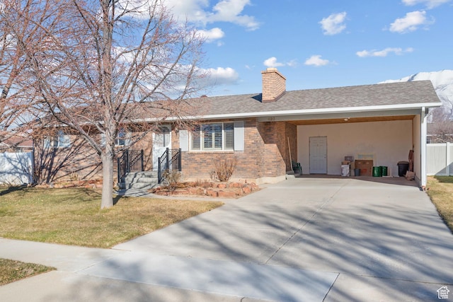 ranch-style house with a chimney, an attached carport, fence, a front yard, and brick siding