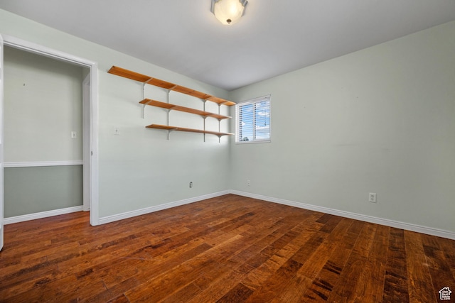 unfurnished room featuring baseboards and hardwood / wood-style flooring