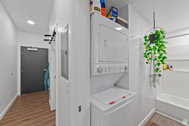 443 W Kane Blvd Unit B305, Moab, UT 84532 - clothes washing area with stacked washer and dryer, baseboards, laundry area, and wood finished floors