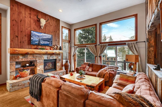 8979 N Timphaven Dr, Sundance, UT 84604 - living room featuring a fireplace, wooden walls, a high ceiling, and wood finished floors