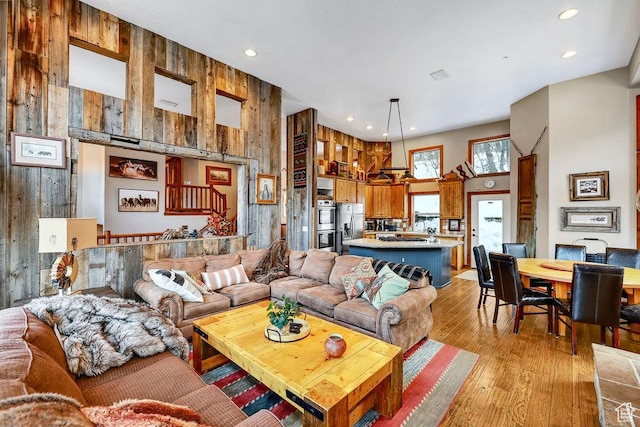 8979 N Timphaven Dr, Sundance, UT 84604 - living area featuring light wood-style floors, recessed lighting, wood walls, and a high ceiling