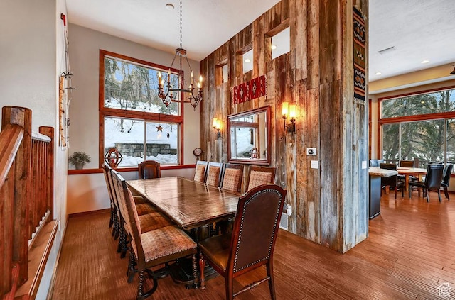 8979 N Timphaven Dr, Sundance, UT 84604 - dining space featuring baseboards, a high ceiling, an inviting chandelier, and wood finished floors