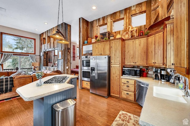 8979 N Timphaven Dr, Sundance, UT 84604 - kitchen with light wood finished floors, stainless steel appliances, light countertops, a sink, and a kitchen island