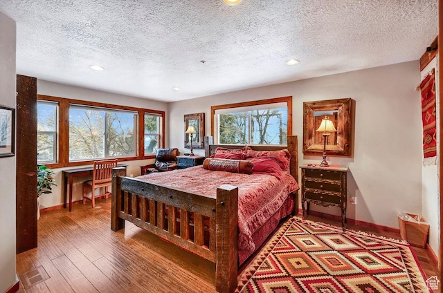 8979 N Timphaven Dr, Sundance, UT 84604 - bedroom with wood-type flooring, multiple windows, and baseboards