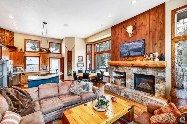 8979 N Timphaven Dr, Sundance, UT 84604 - living room with a high ceiling, a fireplace, wood finished floors, and recessed lighting