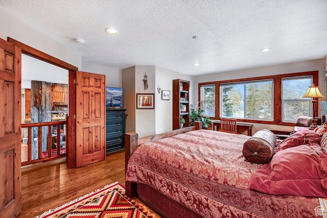 8979 N Timphaven Dr, Sundance, UT 84604 - bedroom featuring recessed lighting, a textured ceiling, and wood finished floors