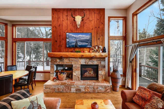 8979 N Timphaven Dr, Sundance, UT 84604 - living room with a fireplace, wood finished floors, a towering ceiling, and baseboards