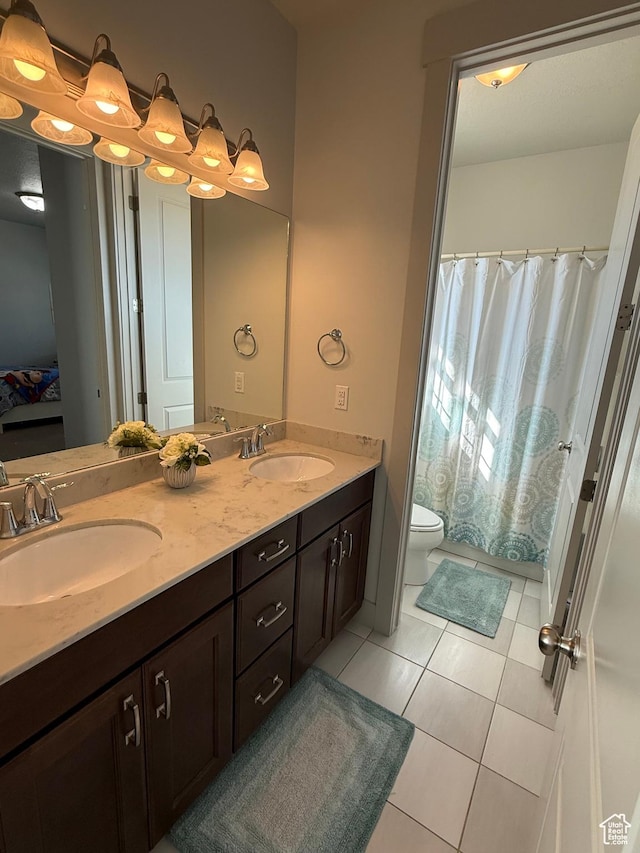 6274 N Vernon Dr E, Eagle Mountain, UT 84005 - full bathroom featuring double vanity, a sink, toilet, and tile patterned floors