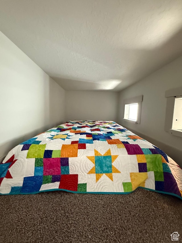 6274 N Vernon Dr E, Eagle Mountain, UT 84005 - carpeted bedroom featuring vaulted ceiling and a textured ceiling