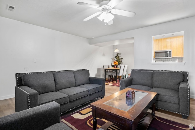 4160 S Oak Meadows Dr W Unit 11, Taylorsville, UT 84123 - living area with ceiling fan, wood finished floors, visible vents, and baseboards