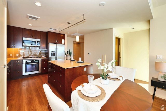 35 E 100 S Unit 1109, Salt Lake City, UT 84111 - kitchen featuring dark wood-style floors, visible vents, stainless steel appliances, and backsplash