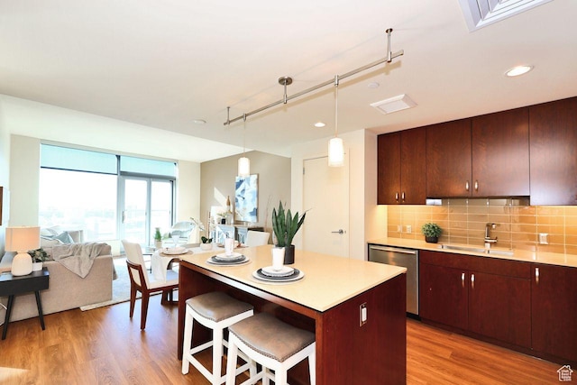 35 E 100 S Unit 1109, Salt Lake City, UT 84111 - kitchen featuring tasteful backsplash, light wood-style floors, a sink, and stainless steel dishwasher