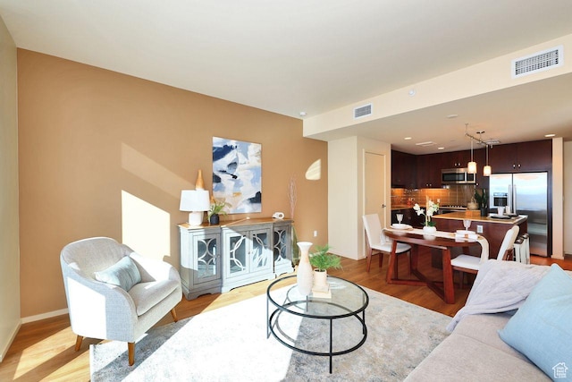 35 E 100 S Unit 1109, Salt Lake City, UT 84111 - living area featuring visible vents, light wood-style flooring, and baseboards