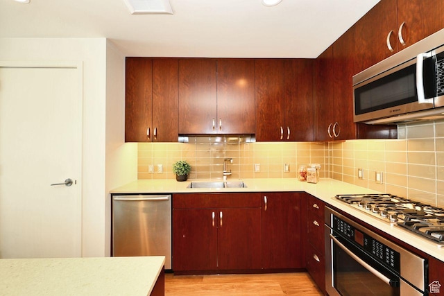 35 E 100 S Unit 1109, Salt Lake City, UT 84111 - kitchen featuring appliances with stainless steel finishes, light countertops, a sink, and decorative backsplash
