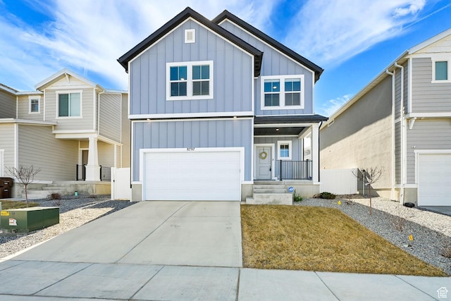 view of front facade featuring board and batten siding, driveway, and a garage