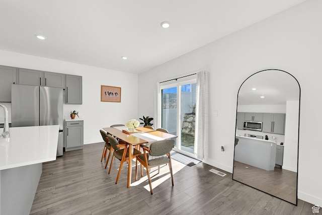 dining space with wood finished floors, recessed lighting, and visible vents