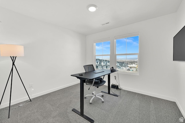 office featuring baseboards, visible vents, and carpet flooring
