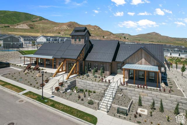 exterior space featuring metal roof, fence, a patio, a standing seam roof, and a mountain view